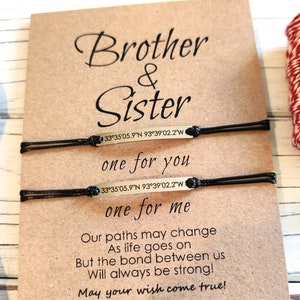 May include: Two black string bracelets with gold metal plates that read "Brother & Sister" and "one for you" and "one for me". The bracelets are displayed on a brown card with the text "Our paths may change As life goes on But the bond between us Will always be strong! May your wish come true!"