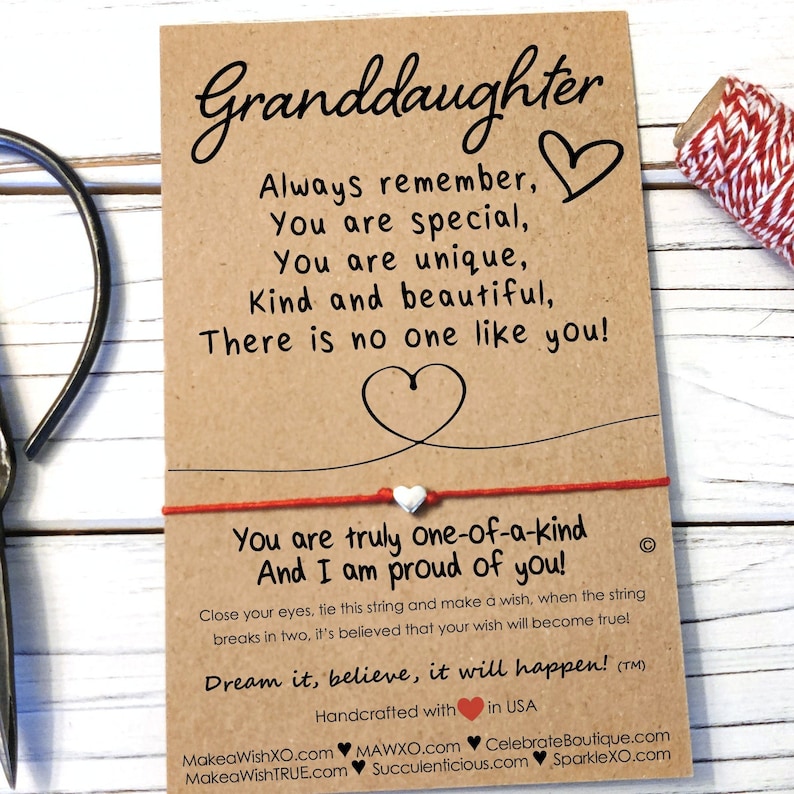 May include: A red string bracelet with a white heart charm and a card that reads "Granddaughter Always remember, You are special, You are unique, Kind and beautiful, There is no one like you! You are truly one-of-a-kind And I am proud of you! Close your eyes, tie this string and make a wish, when the string breaks in two, it's believed that your wish will become true! Dream it, believe, it will happen! (TM) Handcrafted with in USA MakeaWishXO.com MAWXO.com CelebrateBoutique.com MakeaWishTRUE.com Succulenticious.com SparkleXO.com"