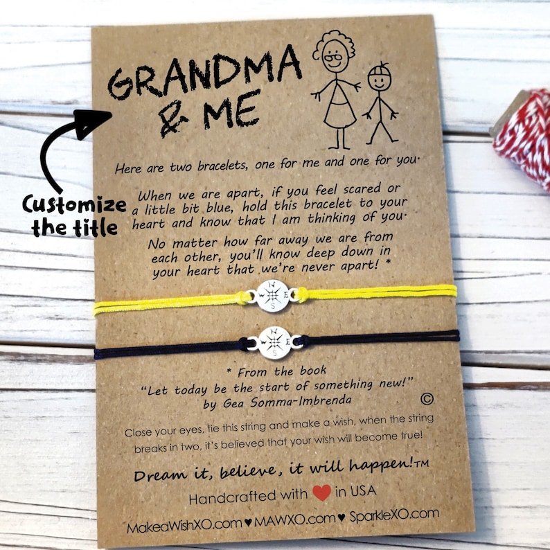 May include: Two friendship bracelets with compass charms and a yellow and black string. The card reads "Grandma & Me" and includes a message about the bracelets representing a connection between two people. The card also includes the text "Dream it, believe, it will happen!"