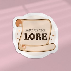 May include: A white sticker with a brown scroll that says "Part of the Lore" in brown text. The scroll is decorated with gold stars.