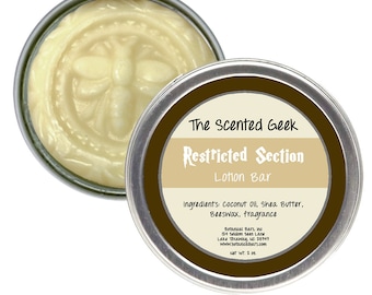 May include: A round, silver tin of lotion bar with the text "Restricted Section Lotion Bar" and "The Scented Geek" printed on the lid. The lotion is a light yellow color and has a bee design. The ingredients are listed on the lid. Net WT. 2 oz.