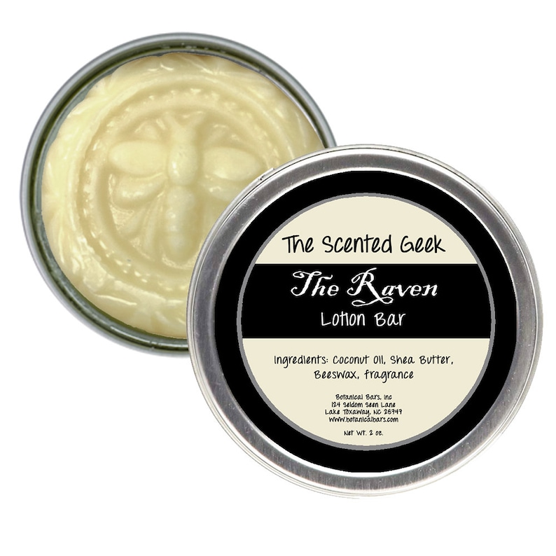 May include: A silver tin of The Raven Lotion Bar by The Scented Geek. The lotion is a light yellow color and has a bee design embossed on the surface. The label lists ingredients and the company's name and website.