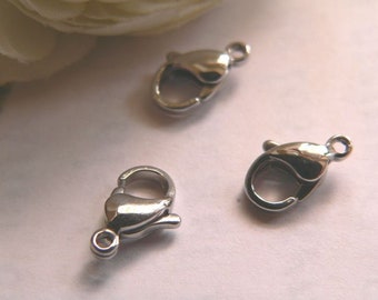 May include: Three silver metal lobster claw clasps. These clasps are commonly used for jewelry making.