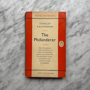 May include: A vintage paperback book titled "The Philanderer" by Stanley Kauffmann, published by Penguin Books. The book has a red and cream cover with text and a penguin logo. The book is complete and unabridged.
