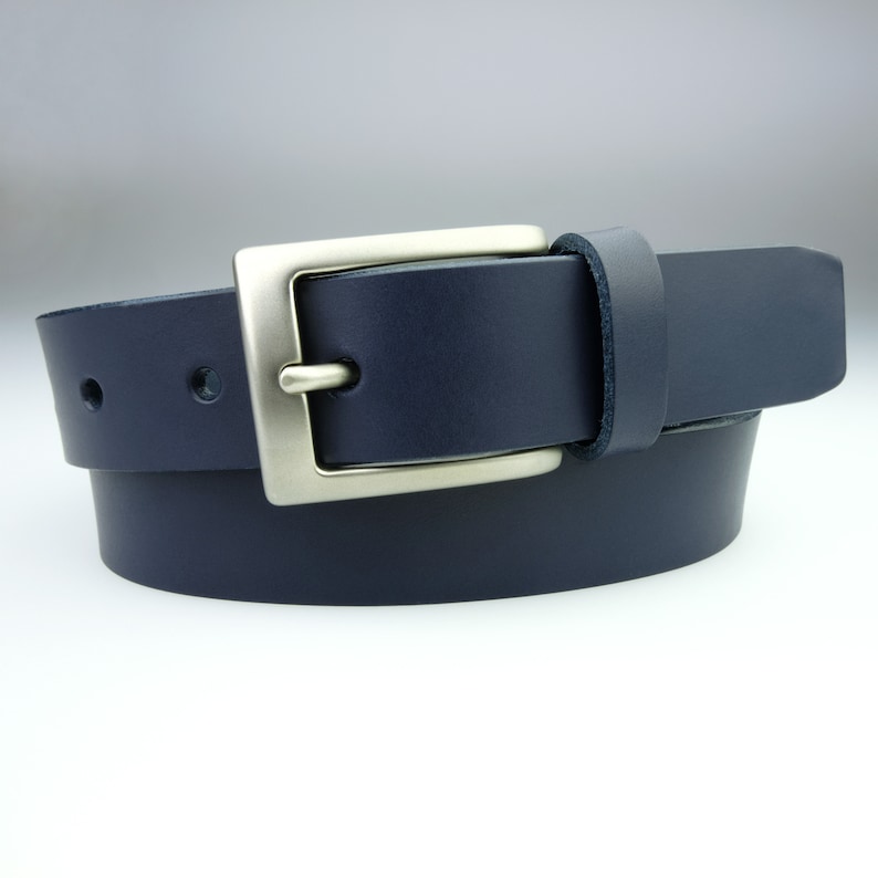 May include: A dark blue leather belt with a silver buckle.