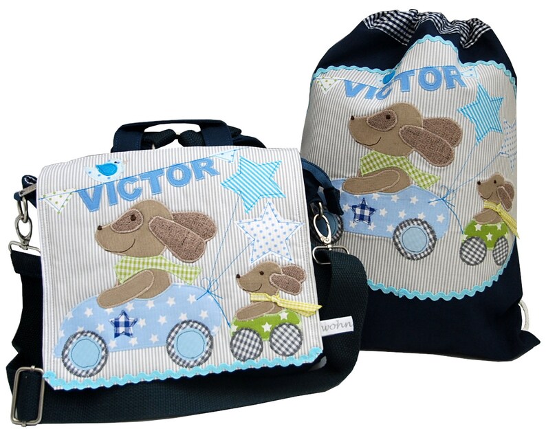 May include: A blue and white backpack and a matching drawstring bag with a dog and car design. The backpack has a name tag that says "VICTOR".