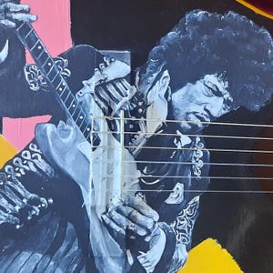 May include: A painting of a musician playing a guitar. The artwork features a portrait of the musician with dark hair, wearing a dark jacket with ornate detailing. The guitar is light blue and white, with strings visible. The background includes pink, yellow, and black.