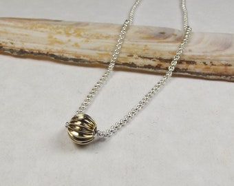 silver chain with gold ball