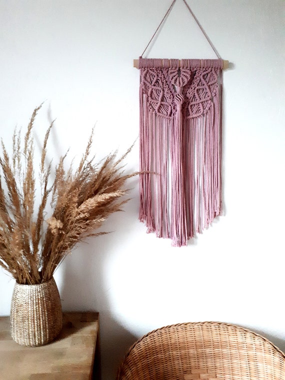 Macrame Wall Hanging In Tan With Green Plants On The Wall