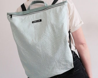 Backpack made of soft and resistant paper-effect faux leather with perforations