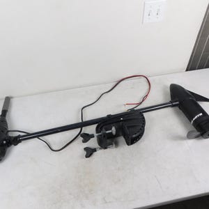 May include: A black and white trolling motor with a propeller. The motor has a long, black shaft and a white head. The motor is designed for use on boats and other watercraft.