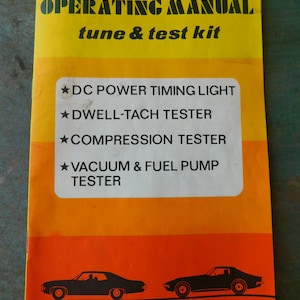 Puede incluir: Un manual de operación vintage naranja y amarillo para un kit de ajuste y prueba para automóviles. El manual enumera los siguientes componentes: luz de sincronización de alimentación de CC, probador de tacómetro de permanencia, probador de compresión, probador de vacío y bomba de combustible. La portada presenta una silueta negra de un automóvil.