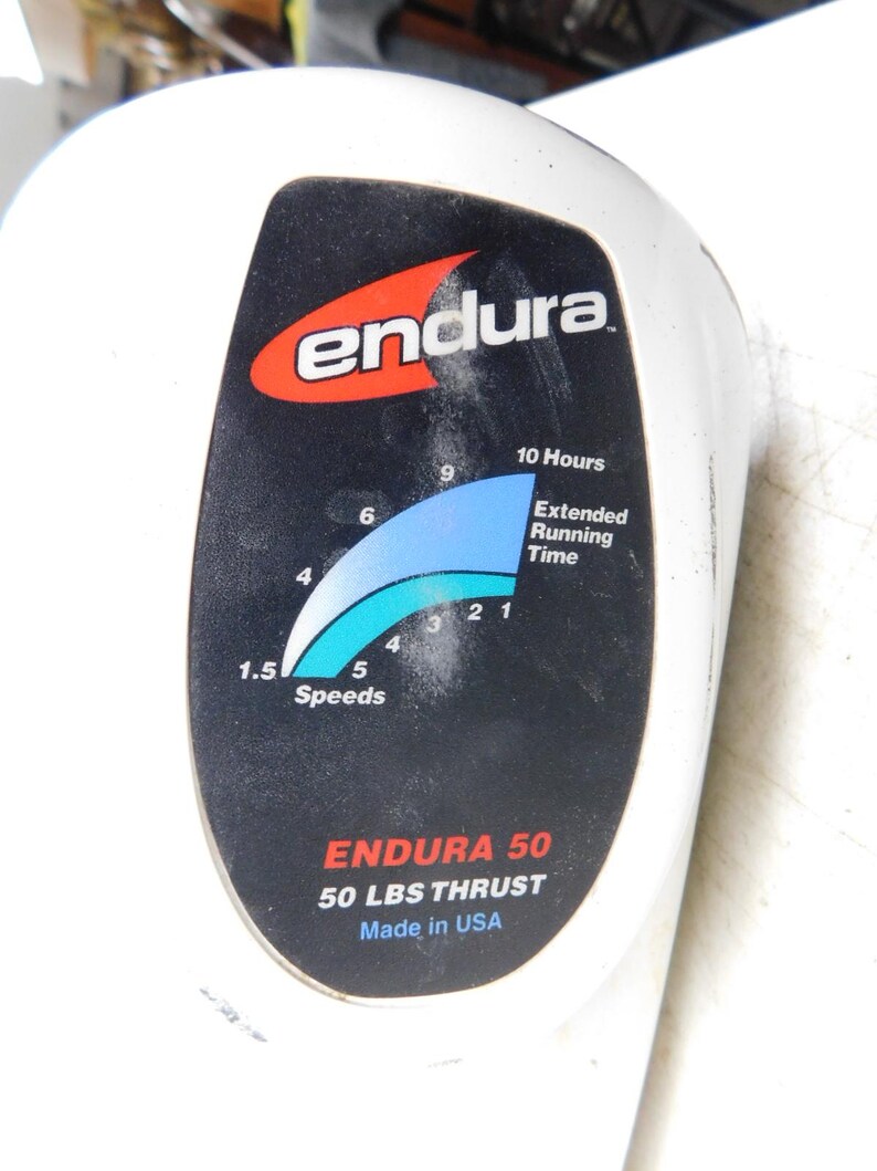 May include: White Endura device with a black panel featuring the brand logo and a blue and white speed indicator. Text includes "ENDURA 50" and "50 LBS THRUST". Made in USA.
