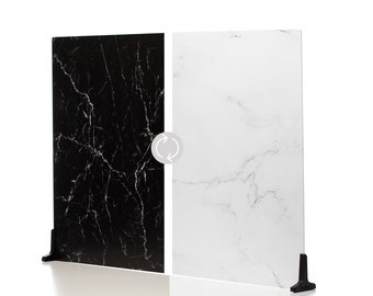 May include: A reversible decorative panel with a black marble-look design on one side and a white marble-look design on the other. The panel is supported by a black stand, and the design is suitable for home decor.