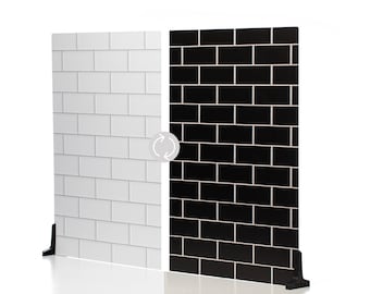 May include: A reversible room divider featuring a white brick pattern on one side and a black brick pattern on the other. The divider has a black base for stability and a white background.