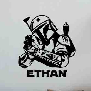 May include: Black and white silhouette of a Star Wars character, Boba Fett, with the name "ETHAN" written below.