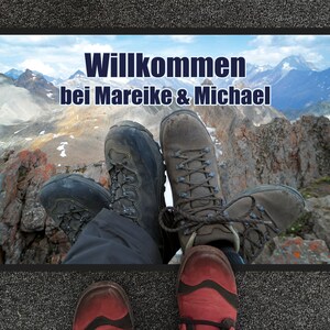 May include: A welcome mat with a mountain scene and the text "Willkommen bei Mareike & Michael".