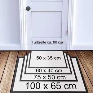 May include: A white door with a black door knob. A black mat with white text showing different sizes in centimeters: 50 x 35 cm, 60 x 40 cm, 75 x 50 cm, 100 x 65 cm. The text "T&uuml;rbreite ca. 80 cm" is above the mat.