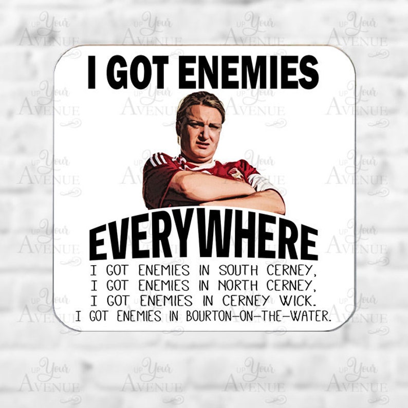 May include: Square coaster with the text "I GOT ENEMIES EVERYWHERE" above and below an image of a man. Additional text lists locations: South Cerney, North Cerney, Cerney Wick, and Bourton-on-the-Water.
