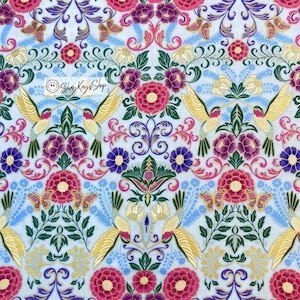 May include: A blue and white floral fabric with gold accents and hummingbirds. The fabric features a repeating pattern of flowers, leaves, and birds. The fabric is perfect for quilting, crafts, and home decor.