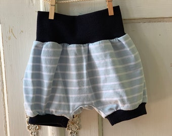 May include: Blue and white striped baby shorts with a black elastic waistband and black trim around the legs.