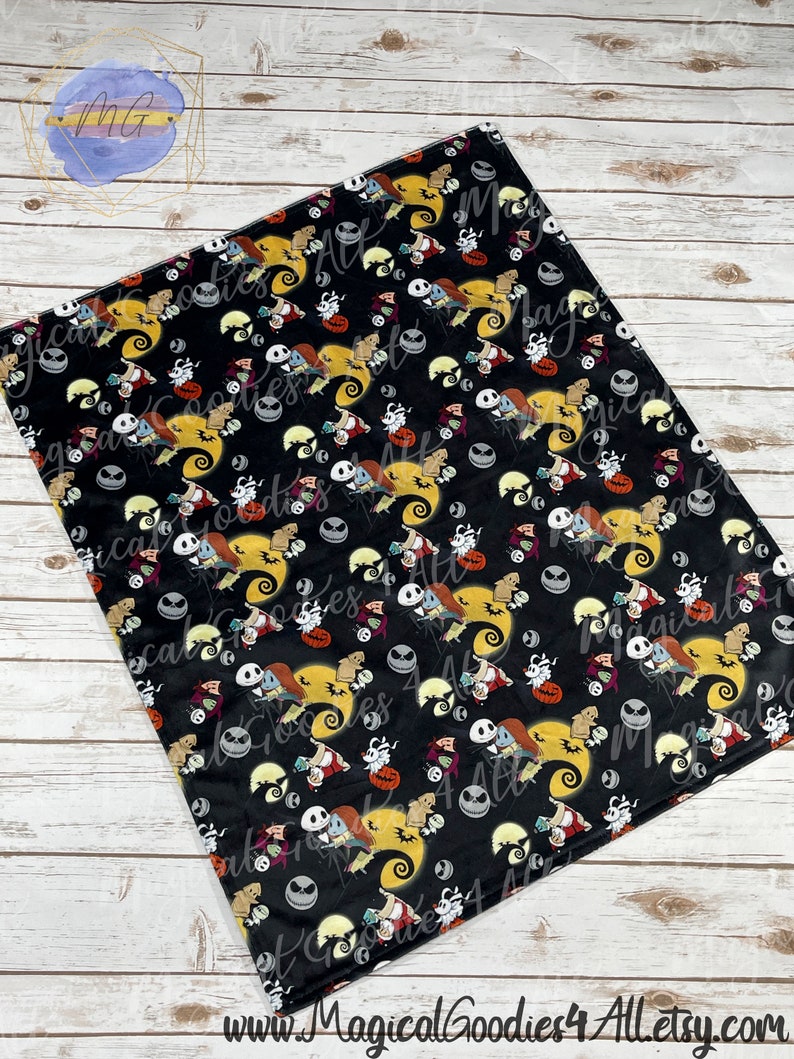 May include: Black blanket featuring a repeating pattern of characters from The Nightmare Before Christmas. The design includes Jack Skellington, Sally, Zero, and other Halloween-themed elements. The blanket has the text "Magical Goodies 4 All Etsy" at the bottom.