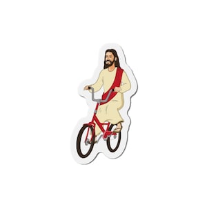 Puede incluir: Una ilustración de dibujos animados de Jesús montando una bicicleta roja. Lleva una túnica beige con una faja roja y tiene una larga barba y cabello castaño.