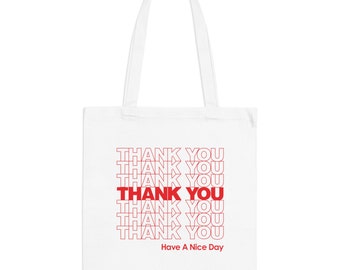 May include: White canvas tote bag with red text that says "THANK YOU" repeated multiple times. The text is in a retro style font. The bottom of the bag says "Have A Nice Day".