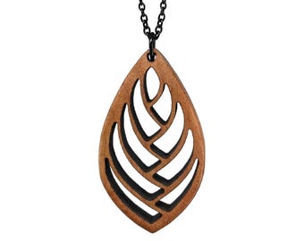 May include: A wooden leaf pendant necklace with a black chain. The pendant is intricately carved with a geometric pattern and has a brown wood finish.
