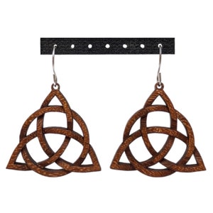 May include: A pair of brown wooden earrings with a Celtic knot design. The earrings are hanging from silver hooks.