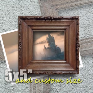 May include: A dark brown wooden picture frame with a carved design. The frame is holding a print of a castle in the fog. The print is 5x5 inches and custom sizes are available.