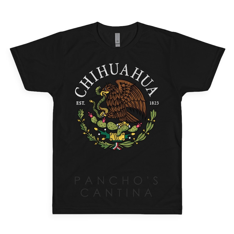 May include: Black t-shirt with a white circle graphic featuring the Mexican coat of arms with a golden eagle, a snake, and a cactus. The text "CHIHUAHUA EST. 1823" is written around the circle. The text "PANCHO'S CANTINA" is written below the circle.
