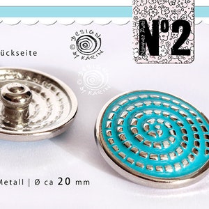 May include: A turquoise blue button with a silver metal rim and a silver metal back. The button has a spiral design and is approximately 20 mm in diameter. The back of the button has a raised center.