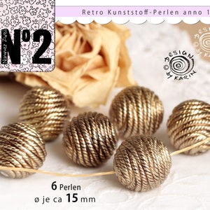 6 attractive pearls from 1960 -| Plastic old gold metallized - from old stock - ø approx. 15 mm each - No. 154