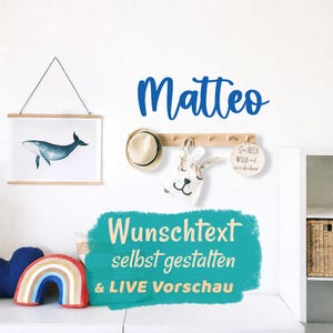 May include: A wall display with a blue whale print, a wooden peg rail holding a hat and bag, and the name "Matteo" in blue script. The text "Wunschtext selbst gestalten & LIVE Vorschau" is also visible.