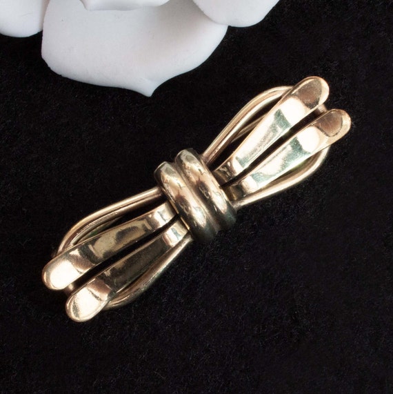 Noeud doré Avon vintage et broche pendante coeur en cristal clair Avon