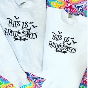 May include: Two gray and white sweatshirts with the text "This is Halloween" and a black and white Jack Skellington face with bats.