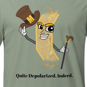 May include: A sage green t-shirt featuring a cartoon character with a brown top hat marked with a yellow M, holding a cane. The character has a smiling face and is surrounded by golden particles. The text reads, Quite Depolarized, Indeed.