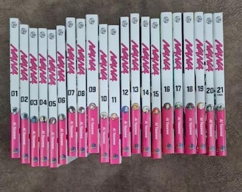 May include: A complete set of 21 manga volumes of NANA by Ai Yazawa. The spines are white with pink lettering and feature the title "NANA" and the volume number. The author's name is printed in black at the bottom of each spine.