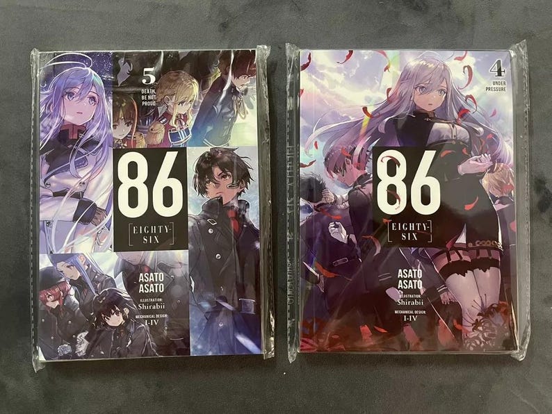 May include: Two volumes of the 86 Eighty-Six manga series. The covers feature anime-style illustrations of characters from the series. The first volume is volume 5, and the second volume is volume 4. The text on the covers reads "86 Eighty-Six" and "Asato Asato".