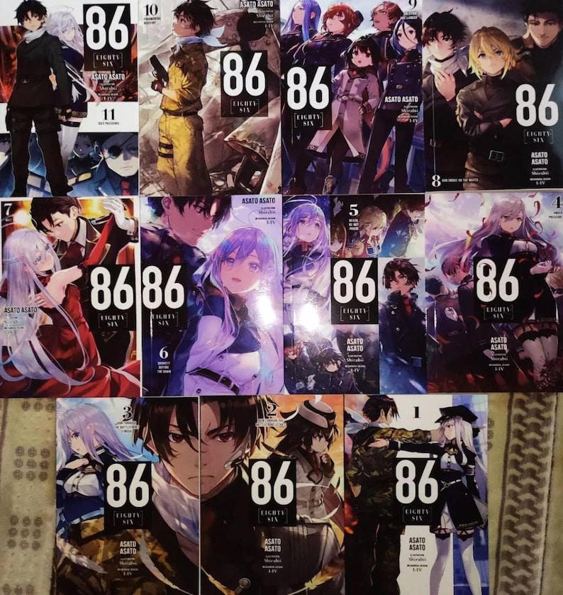 May include: A collection of 11 manga volumes of the series "86 - Eighty Six" by Asato Asato. The covers feature colorful illustrations of characters from the series, including a young woman with blue hair and a young man with brown hair.