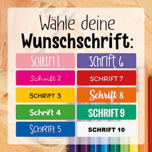 May include: A colorful chart with the text "W&auml;hle deine Wunschschrift" (Choose your desired font) and ten different font styles labeled "Schrift 1" through "Schrift 10".