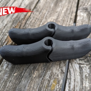 May include: Two black 3D printed bike brake levers with a textured surface. The levers are designed to fit on a bicycle handlebar.
