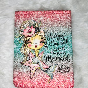 May include: A pink and blue glitter background with a cartoon mermaid with blonde hair and a pink starfish. The text reads "Always be yourself... unless you're a Mermaid then always be a mermaid."