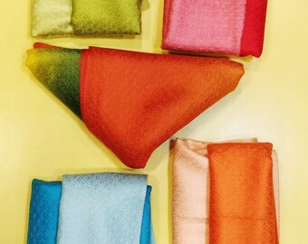 May include: Five folded fabric pieces with a subtle geometric texture. Colors include light green, dark green, pink, red, orange, blue, light blue, and peach. A circular logo in the bottom right corner reads JL LOVE LOVE Gallery SINCE 1991.