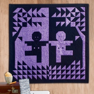 May include: Purple and black quilt featuring two stylised figures standing under a tree. The quilt is made of triangles and has a textured fabric.
