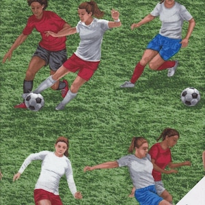 May include: A green fabric with a repeating pattern of girls playing football. The girls are wearing white, red, and blue jerseys and shorts. There are footballs on the pitch.