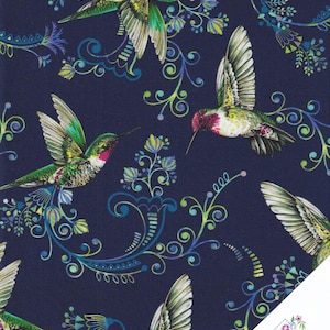May include: Dark navy fabric featuring a repeating pattern of hummingbirds and floral designs in green, white, pink, and blue. The hummingbirds are in various poses. The fabric has a Quilt Shop logo.