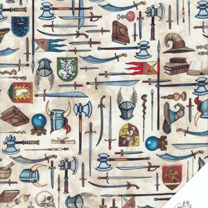 May include: A beige fabric featuring a repeating pattern of assorted medieval weaponry and objects, such as swords, axes, shields, helmets, wands, and potions. The fabric is ideal for crafting projects, quilting, and other creative pursuits.