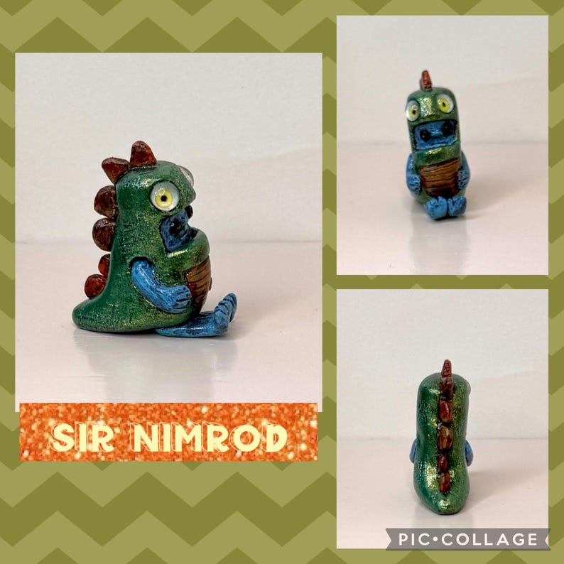 May include: A handmade figurine of Sir Nimrod, a green and blue creature with a red spine. The figurine has large yellow eyes and is seated. The text "SIR NIMROD" is displayed on a glittery orange banner.